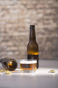 Glass of wine bottles on table