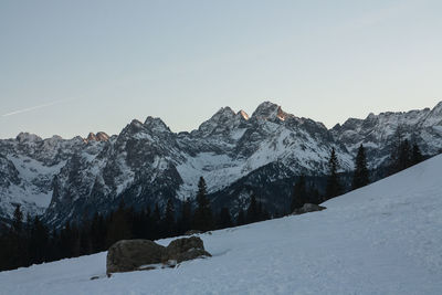 Scenic view of snowcapped mountains against clear sky