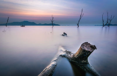 Scenic view of lake against sky during sunset