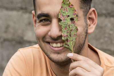 Close-up portrait of smiling young man