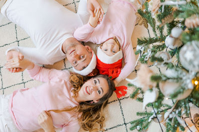 Christmas. family and happiness. top view of dad, mom and daughter wearing