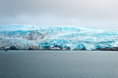 Scenic view of sea against sky during winter