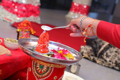 Midsection of woman holding ice cream in temple