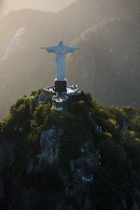 Statue on mountain against sky