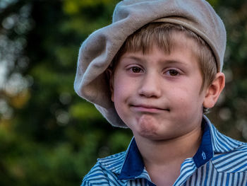 Close-up portrait of boy wearing flat cap