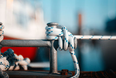Close-up of rope tied on metal railing