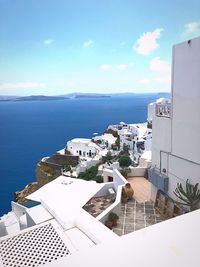 High angle view of buildings by sea against sky