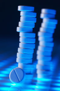 Close-up of illuminated light against blue background