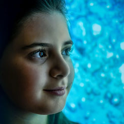 Close-up portrait of smiling girl swimming in pool