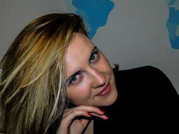 Portrait of smiling young woman against white background