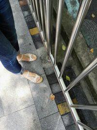 Low section of person standing on tiled floor