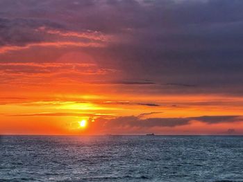 Scenic view of sea against romantic sky at sunset