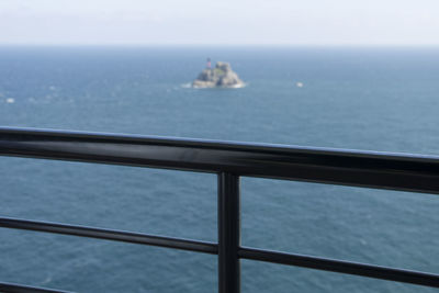 Close-up of boat sailing on sea against sky