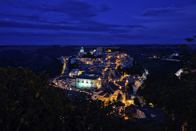 Aerial view of illuminated buildings in city at night