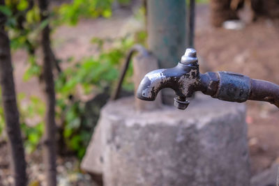 High angle view of old faucet on rock