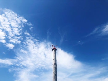 Low angle view of crane against blue sky