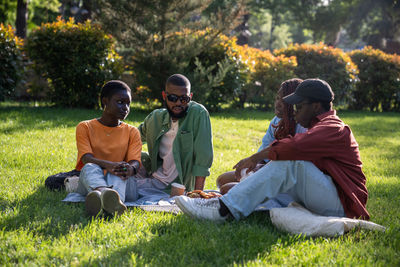 Friends sitting on field