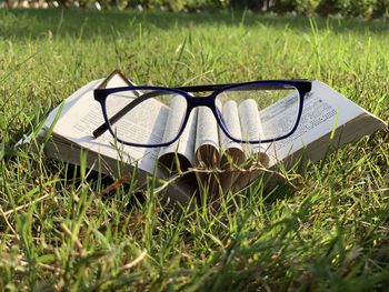 Close-up of sunglasses on field