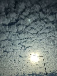 Low angle view of illuminated snow against sky during winter