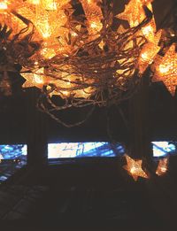 Low angle view of illuminated lanterns hanging at night