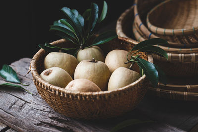 Close-up of fruits in basket on table