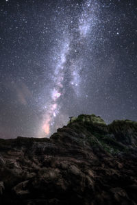 Scenic view of mountains against sky at night