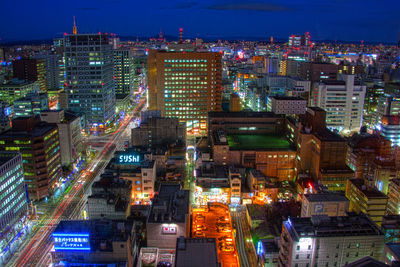 High angle view of city lit up at night