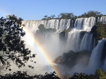 Low angle view of waterfall against sky