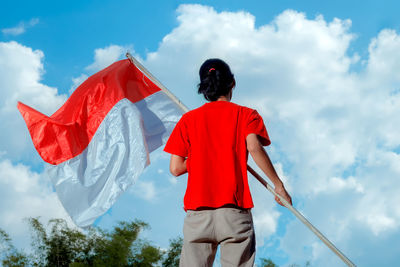 A person holding the indonesian national flag. indonesian independence day