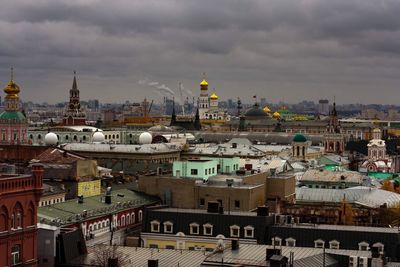 Cityscape against cloudy sky