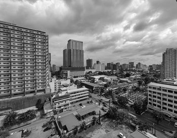 Cityscape against cloudy sky