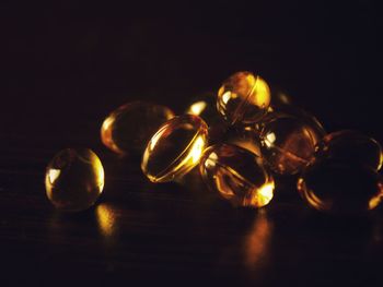 Close-up of candles on table against black background