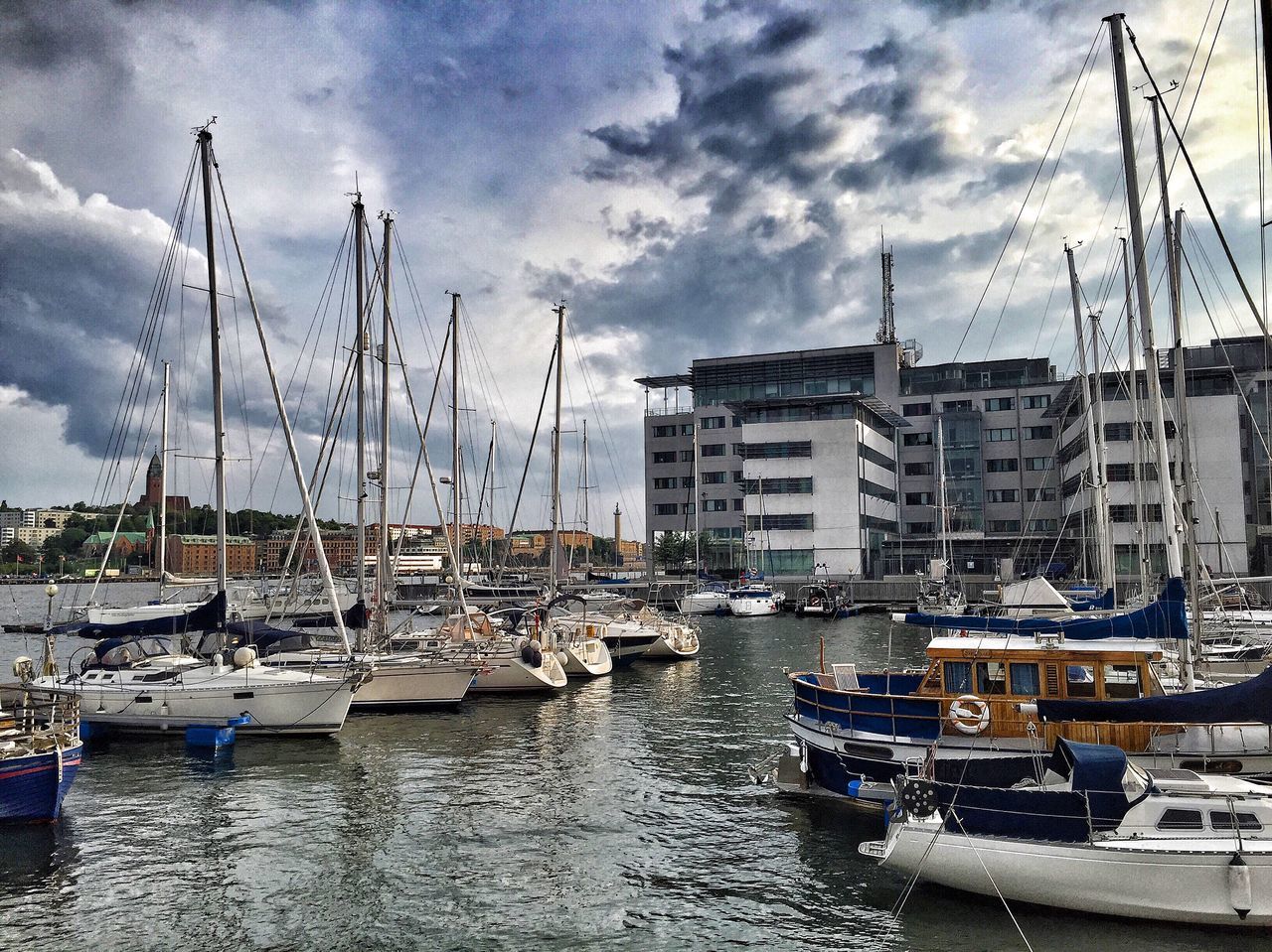 nautical vessel, moored, water, transportation, boat, sky, mode of transport, harbor, cloud - sky, mast, cloudy, cloud, waterfront, sailboat, building exterior, sea, built structure, architecture, marina, outdoors