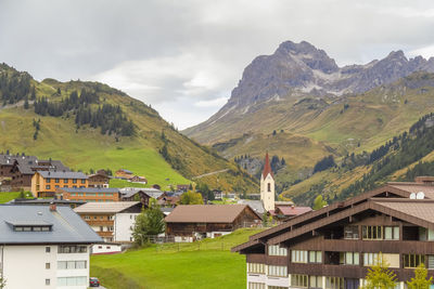 Houses and mountains against sky