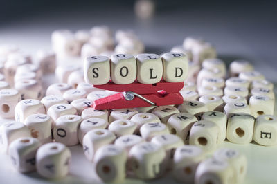 Close-up of text with clothespin on blocks over table