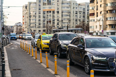 Cars on street by buildings in city