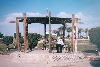 Rear view of people at observation point against sky