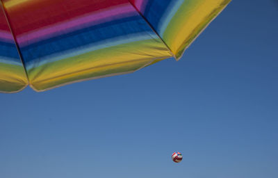 Low angle view of parasol against sky