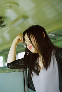 Low angle view of woman looking away while in train