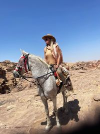 Low angle view of woman riding horse