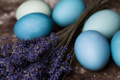 Happy easter rustic concept with copy space. diy dyed blue easter eggs and lavender background.