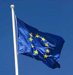 Low angle view of european flag against clear blue sky