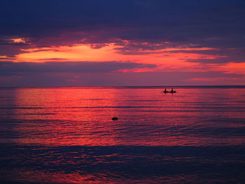 Scenic view of sea against orange sky