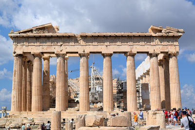 Low angle view of historical building against cloudy sky