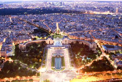 Aerial view of city lit up at night