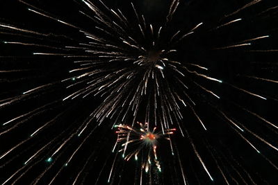 Low angle view of firework display at night