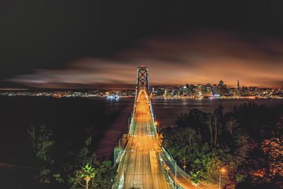 High angle view of bay bridge over ocean at night