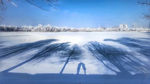 Scenic view of frozen landscape against blue sky