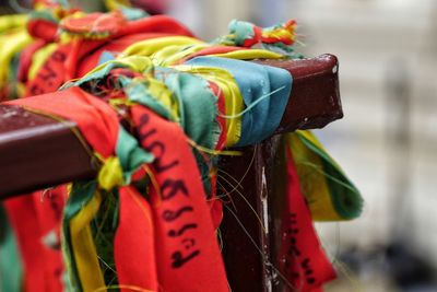Close-up of prayer flags tied on railing