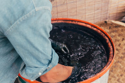 Midsection of man working in dye